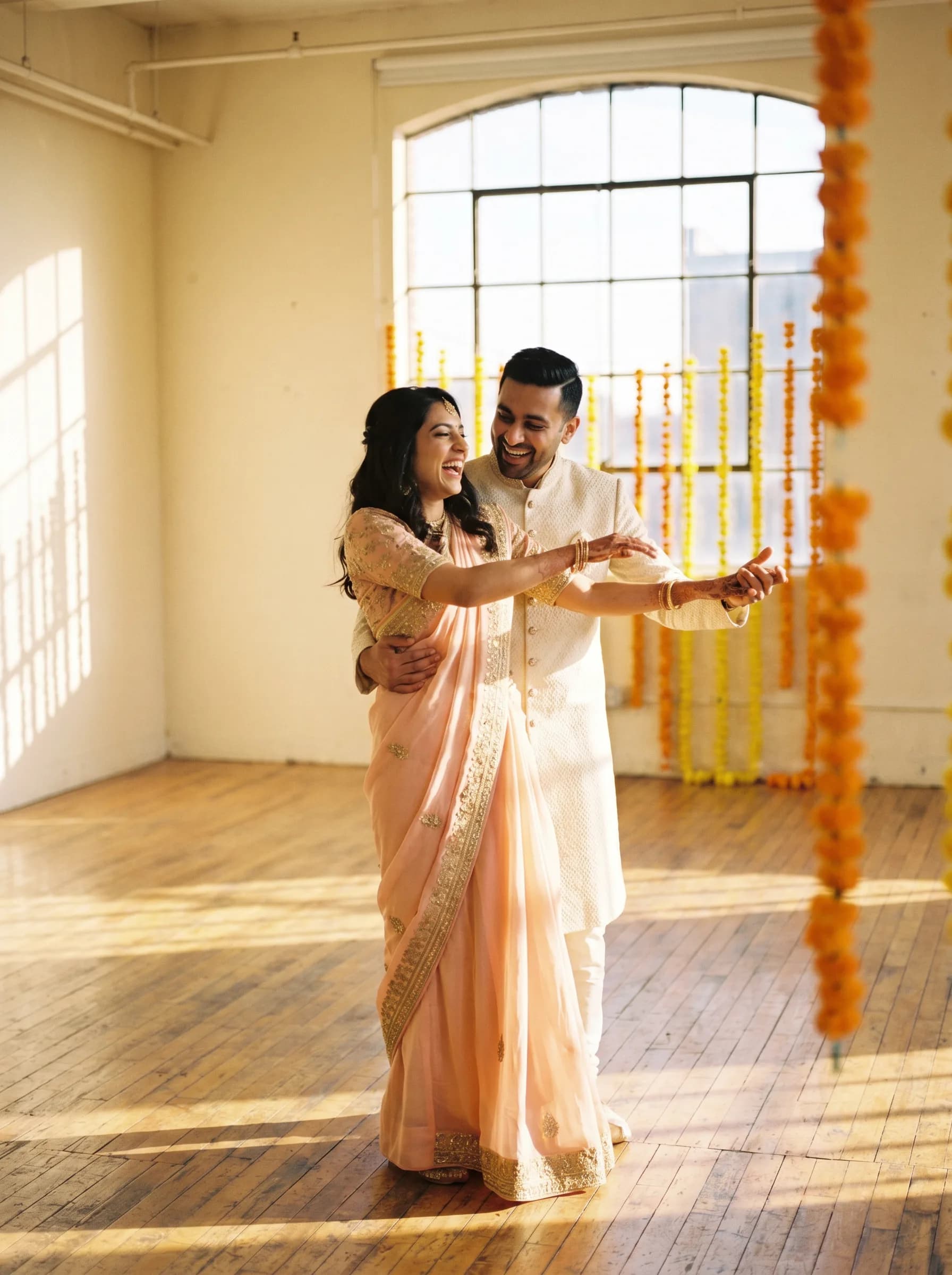 An Indian couple practising sangeet wedding choreography